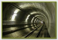 tunnel with train tracks and industrial lighting